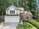 Charming two-story home with a well-manicured lawn, stone accents, and a two-car garage, showcasing curb appeal at 4816 Morning Chase Nw, Acworth, GA 30102