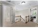 Upstairs hallway features carpeted floor and entryways into the bedrooms and an open view of the stairwell at 4816 Morning Chase Nw, Acworth, GA 30102