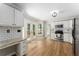 Modern kitchen boasts stainless steel appliances, white cabinets, granite countertops, and access to outdoor deck at 4816 Morning Chase Nw, Acworth, GA 30102