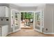 A view from the kitchen through the double doors to the outdoor deck with seating and a grill at 4816 Morning Chase Nw, Acworth, GA 30102