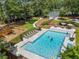 Aerial view of a community pool with lounge chairs, playground, and well-maintained landscaping at 4816 Morning Chase Nw, Acworth, GA 30102