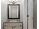 Stylish powder room featuring vanity with granite countertop, updated fixtures, and adjacent door at 4816 Morning Chase Nw, Acworth, GA 30102