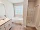Bathroom featuring a shower, bathtub, large window, and vanity with sink at 1102 Ola Dale Ct, Mcdonough, GA 30252