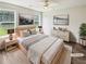 A staged bedroom is bright with natural light, neutral colors, wood flooring and modern furniture at 1102 Ola Dale Ct, Mcdonough, GA 30252