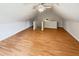 A bonus room featuring laminate floors, neutral walls, access to stairs, and a ceiling fan at 1102 Ola Dale Ct, Mcdonough, GA 30252