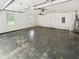 A spacious garage with an overhead fan, two windows, access door and water heater at 1102 Ola Dale Ct, Mcdonough, GA 30252
