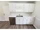 Efficient kitchen featuring stainless steel dishwasher, white cabinets and countertops and modern faucet at 1102 Ola Dale Ct, Mcdonough, GA 30252