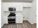 Well-equipped kitchen boasts stainless steel appliances, ample countertop space, and white cabinetry at 1102 Ola Dale Ct, Mcdonough, GA 30252
