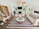 Bright living room boasts a fireplace, modern decor, and wood-look flooring for a cozy atmosphere at 1102 Ola Dale Ct, Mcdonough, GA 30252