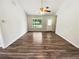 Bright, airy room with wood-look flooring, large window, and neutral walls at 1102 Ola Dale Ct, Mcdonough, GA 30252