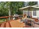 Back deck with outdoor grill, chairs, and table, with a view of trees at 1151 Roxboro Ne Cv, Atlanta, GA 30324