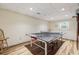 Finished basement with ping pong table, wood-look floors, and recessed lights at 1151 Roxboro Ne Cv, Atlanta, GA 30324