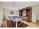 Finished basement with ping pong table, wood-look floors, and built-in shelving at 1151 Roxboro Ne Cv, Atlanta, GA 30324