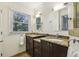 Bathroom featuring granite countertops, double sinks, and natural light at 1151 Roxboro Ne Cv, Atlanta, GA 30324
