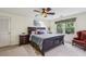 Comfortable bedroom with a ceiling fan, plush carpet, and a large window at 1151 Roxboro Ne Cv, Atlanta, GA 30324