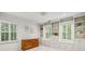 Well lit bonus room featuring built-in bookshelves, cabinets and window seat storage at 1151 Roxboro Ne Cv, Atlanta, GA 30324