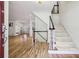 Welcoming foyer featuring hardwood floors, a staircase, and access to multiple living spaces at 1151 Roxboro Ne Cv, Atlanta, GA 30324