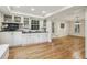 Bright kitchen features white cabinets, hardwood floors, and access to a dining room for easy entertaining at 1151 Roxboro Ne Cv, Atlanta, GA 30324