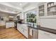 Stylish kitchen with white cabinetry, granite countertops, stainless appliances, and a farmhouse sink at 1151 Roxboro Ne Cv, Atlanta, GA 30324