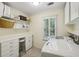 Efficient laundry room with white cabinets, shelving, and front-loading washer and dryer at 1151 Roxboro Ne Cv, Atlanta, GA 30324