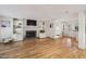 Open-concept living area with hardwood floors, brick fireplace, built-in shelving, and ample natural light at 1151 Roxboro Ne Cv, Atlanta, GA 30324