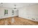 Open concept living space with hardwood floors and natural light from windows with traditional shutters at 1151 Roxboro Ne Cv, Atlanta, GA 30324