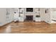 Spacious living room featuring hardwood floors, a brick fireplace, and built-in shelving for storage and display at 1151 Roxboro Ne Cv, Atlanta, GA 30324