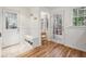 Mudroom with tile and wood floors, beadboard wainscoting, and a built-in bench with storage at 1151 Roxboro Ne Cv, Atlanta, GA 30324