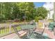 Deck with dining table, grill, lush green lawn, and covered patio area at 1461 Radstone Dr, Lawrenceville, GA 30044