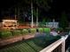 Landscaped backyard with a beautiful pergola, stone retaining wall, hammock and lush greenery at 1461 Radstone Dr, Lawrenceville, GA 30044