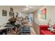 Finished basement featuring a drumset, guitars, and red couch with wood flooring at 1461 Radstone Dr, Lawrenceville, GA 30044