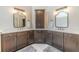 Modern bathroom featuring dual sinks, marble countertops, and elegant mirrors at 1461 Radstone Dr, Lawrenceville, GA 30044