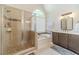 Bright bathroom with a glass-enclosed shower, soaking tub, and vanity with storage at 1461 Radstone Dr, Lawrenceville, GA 30044
