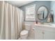 Charming bathroom with a white vanity, oval mirror, and a shower with a decorative curtain at 1461 Radstone Dr, Lawrenceville, GA 30044