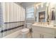 Fresh bathroom showcasing tub with shower, toilet, and vanity with white cabinets at 1461 Radstone Dr, Lawrenceville, GA 30044