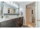Bathroom features a double sink vanity with gray cabinets and a marble countertop at 1461 Radstone Dr, Lawrenceville, GA 30044