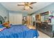 Comfortable bedroom with blue walls, a ceiling fan, and an adjacent bathroom entrance at 1461 Radstone Dr, Lawrenceville, GA 30044