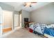 Cozy bedroom with neutral walls, carpet, ceiling fan, and a small TV stand at 1461 Radstone Dr, Lawrenceville, GA 30044