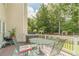 Deck with dining table, grill, and view of backyard landscaping at 1461 Radstone Dr, Lawrenceville, GA 30044