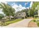 Charming home with a long driveway, mature trees, and green grass at 1461 Radstone Dr, Lawrenceville, GA 30044