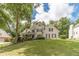 Beautifully landscaped front yard with mature trees at 1461 Radstone Dr, Lawrenceville, GA 30044