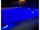 Relaxing hot tub with blue lights and view of the gazebo in the backyard at 1461 Radstone Dr, Lawrenceville, GA 30044