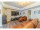 Cozy living room with a comfortable leather sofa, entertainment center, and modern lighting at 1461 Radstone Dr, Lawrenceville, GA 30044