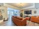 Spacious living room with modern entertainment center, comfortable seating and wet bar in background at 1461 Radstone Dr, Lawrenceville, GA 30044
