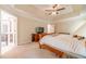 Main bedroom with trey ceilings, ceiling fan, and adjoining bathroom at 1461 Radstone Dr, Lawrenceville, GA 30044