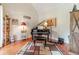 Cozy piano room featuring hardwood floors, a piano, and natural light at 1461 Radstone Dr, Lawrenceville, GA 30044