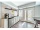 Stylish wet bar with a sink, mini-fridge, wood-look wall and access to the outdoor patio at 1461 Radstone Dr, Lawrenceville, GA 30044