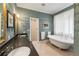 Elegant bathroom with a soaking tub, double sink vanity, and tiled shower with tasteful decor at 2837 N Hills Ne Dr, Atlanta, GA 30305