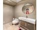 A modern bathroom features a sleek vessel sink, a round mirror, and a tiled floor at 2837 N Hills Ne Dr, Atlanta, GA 30305