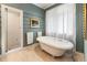 Bathroom with soaking tub, stand-up shower, and artistic accent wall at 2837 N Hills Ne Dr, Atlanta, GA 30305